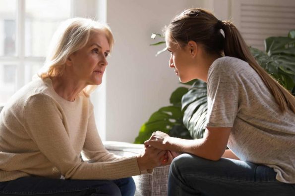 a mother and a daughter in a deep conversation